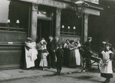 Hommes, femmes et enfants devant une taverne à Londres - English Photographer